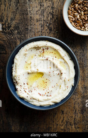 Hummus in a bowl with oil and spices Stock Photo