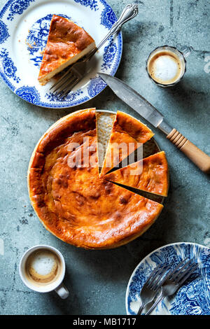 Sliced New York style cheesecake and 2 cups of coffee on a metal background Stock Photo