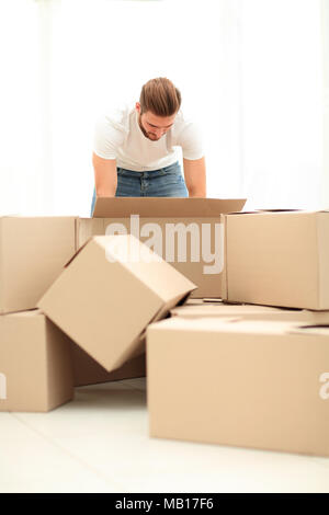 male sorting things in the new apartment. Stock Photo