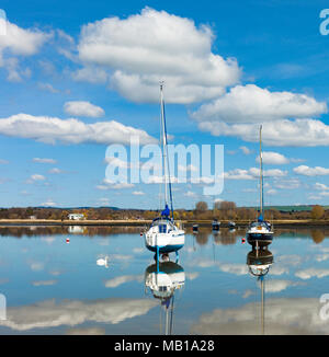 Sailing boats moored in still waters, Dell Quay, Chichester harbour. Stock Photo