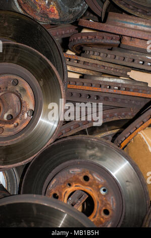 Rusty corroded worn out old brake discs piled up waiting to go for recycling Stock Photo