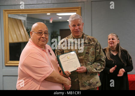 Oscar Sanchez receives a letter of appreciation from the Commander of the 81st Regional Support Command, MG Arlen DeBlieck, during his retirement ceremony held on Fort Jackson, SC, for his nearly 50 years of service to the U.S. Army Reserve. Stock Photo