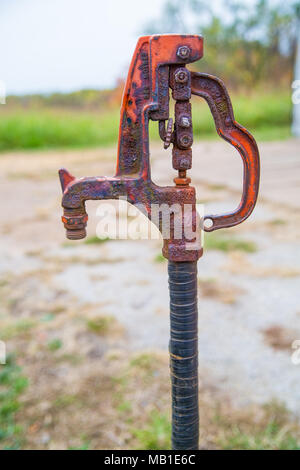 Old rusted hand pump water spigot used on a farm Stock Photo