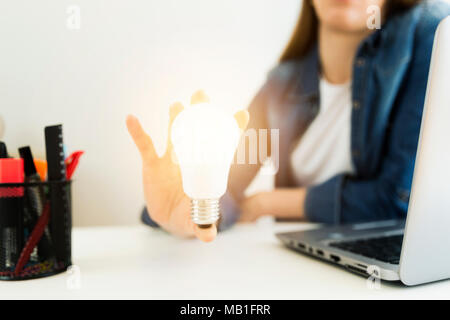 Business women's, designer's hand holding light bulb, concept of new ideas with innovation and creativity. Stock Photo