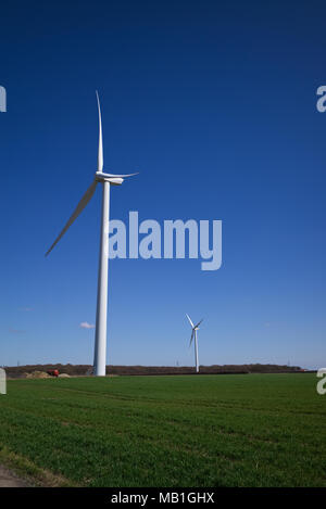 The Wind Turbines on farmland near Clacton on Sea Essex are the largest land wind turbines in the UK. Stock Photo