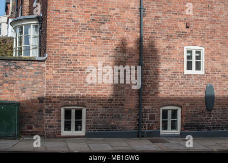 Basement windows lead out overlooking the pathway in a Shrewsbury property in Shropshire Stock Photo