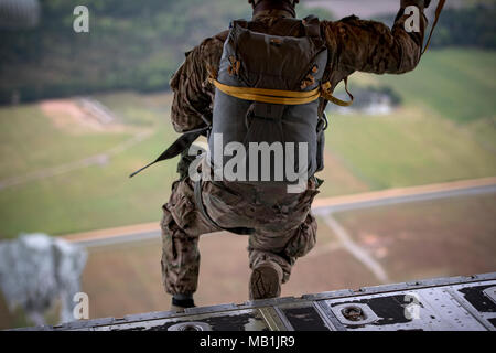 An Airman from the 820th Base Defense Group jump from an HC-130J Combat King II during static-line jump proficiency training, March 30, 2018, in the skies over Moody Air Force Base, Ga. The 820th BDG and the 71st RQS work together frequently so the defenders and the aircrew can maintain their qualifications. (U.S. Air Force photo by Staff Sgt. Ryan Callaghan) Stock Photo