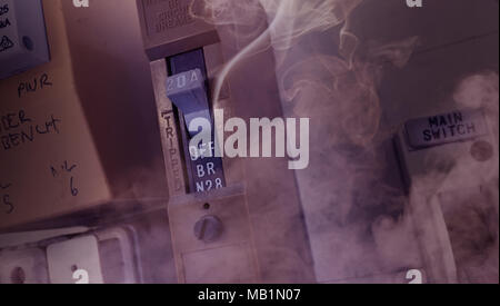 Pre ignition smoke coming from an old electrical fuse box relating in a house fires Stock Photo