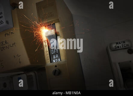 Sparks flying from an old electrical switch which causes a house fire Stock Photo