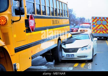 Bartlett, Illinois, USA. School bus was rear ended with sufficient force to lift the bus' reat wheels off the road. Stock Photo