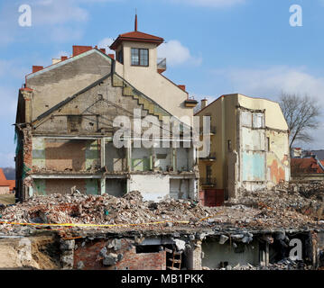 A huge pile of bricks. concrete stones  and construction debris remained after the destruction of the dilapidated apartment house. Panoramic front vie Stock Photo