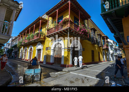 Cartagena, Colombia - August 3, 2017: Unidentified people walking through a typical Cartagena street with colonial architecture in Cartagena, Colombia Stock Photo