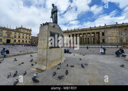Bogota, Colombia - August 24, 2017: People in the Bolivar square next to the statue of Simon Bolivar and the National Capitol in Bogota, Colombia. Stock Photo
