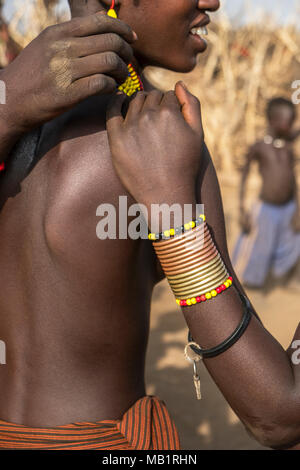 OMORATE, ETHIOPIA - JANUARY 25, 2018: Detail of an unidentified woman forming a circle singing and dancing in their village near the Omorate river. Stock Photo