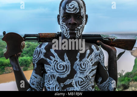 Omo Valley, Ethiopia - January 26, 2018: Unidentified Karo man poses with firearm in his hand in Omo valley, Ethiopia. Stock Photo