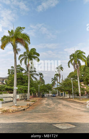A street running perpendicular to the Beach road, with its Palm Lined avenue heading into town, on Sao Tome Island in West Africa. Stock Photo