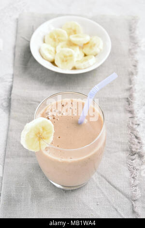 Banana smoothie in glass. Healthy natural or vegetarian vegan beverage concept. Stock Photo
