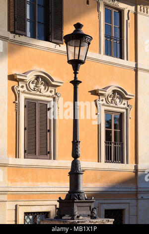 A street lamp in Piazza del Spagna, Rome, Italy. Taken as the setting sun creates angled shadows across the pastel coloured buildings, the light (like Stock Photo