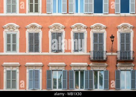 Windows and shutters on a terracotta coloured building in Piazza del Spagna, Rome, Italy. Stock Photo