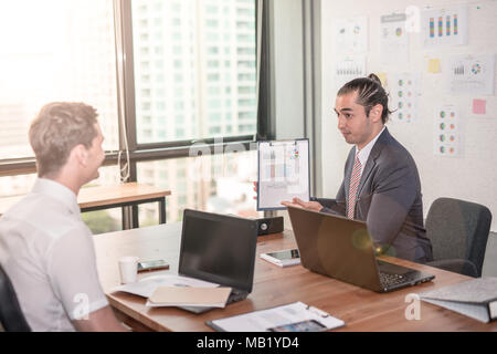 business partners discussing documents and ideas at meeting Group of business people sharing their ideas. Stock Photo