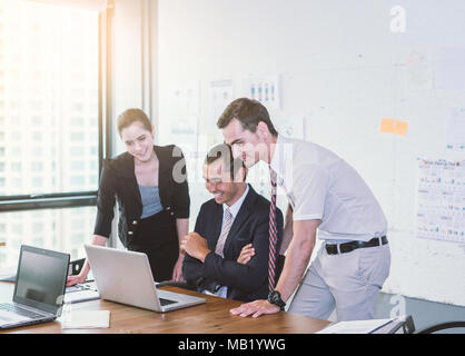 Business team having using laptop during a meeting and presents. Stock Photo