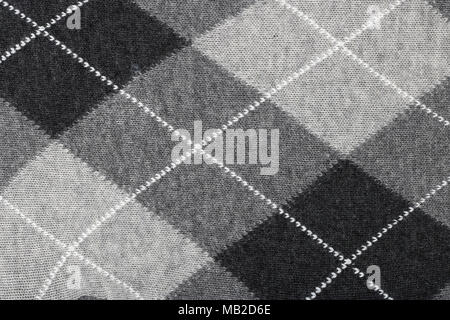 Pattern of a warm female sweater from black and white rhombuses and lines. Mass production background Stock Photo