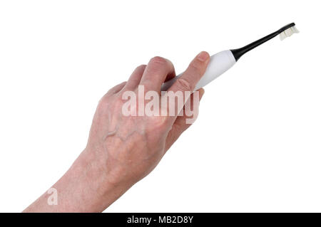 An elderly man holds an electric mass production toothbrush in his hand. Isolated on white with patch studio shot Stock Photo