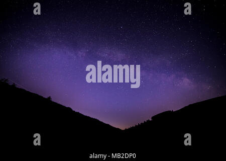 Milky Way arching over the Clwydian Forest at Moel Famau, North Wales Stock Photo