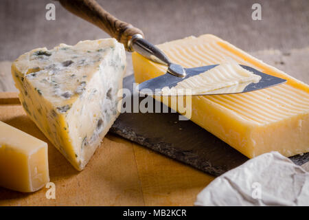 Mold blue cheese and cheddar on cutting board. Stock Photo