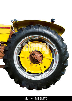 Vertical close-up shot of a big yellow tractor tire. Stock Photo