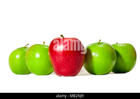 Horizontal straight on shot of one red delicious apple standing in front of four green granny smith apples on a white background. Stock Photo