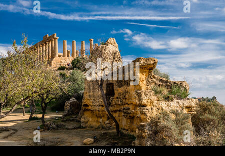 The remains of the city walls of the ancient Greek Akragas and of the temple of Juno, in the Valley of the Temples, in Agrigento, Sicily, Italy. Stock Photo