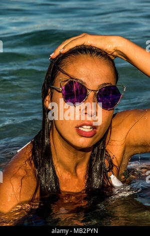 Fashion Model In Swimming Pool Wearing Bikini And Sunglasses Stock