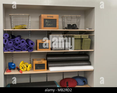 Shelf of work out equipment in modern gym. Yoga, classes, stretching,  steps, rollers Stock Photo - Alamy