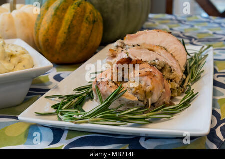 Turkey and Stuff Rolls on Dinner Plate with Rosemary Garnish Stock Photo