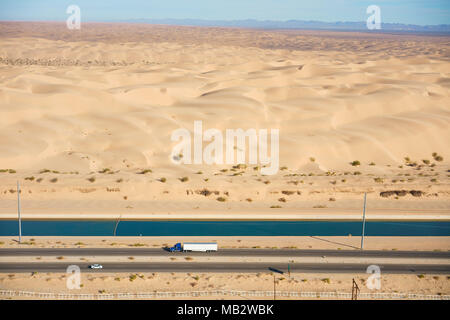 AERIAL VIEW. All American Canal alongside Interstate 8 in the Algodones Dunes in the Sonoran Desert. Winterhaven, Imperial County, California, USA. Stock Photo