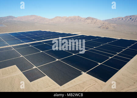 AERIAL VIEW. Large field of photovoltaic panels in the rocky Mojave Desert. Stateline Solar Facility, Nipton, San Bernardino County, California, USA. Stock Photo
