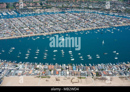 AERIAL VIEW. Balboa Peninsula in the foreground with Balboa Island behind. Newport Beach, Orange County, California, USA. Stock Photo