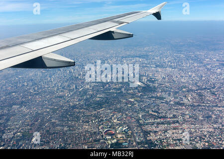 View from a plane with wing on city centre, aerial view, Bangkok, Thailand Stock Photo