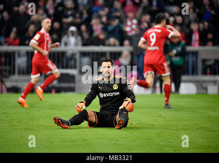 Goalkeeper Roman Bürki Borussia Dortmund disappointed after conceding goal, Bayern players cheer in the background Stock Photo