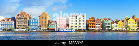 Panoramic view of the colorful and famous buildings at the Handelskade waterfront, Willemstad, Curacao, Caribbean, January 2018 Stock Photo