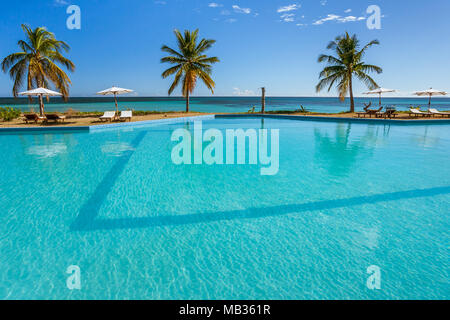 Tropical swimming pool overlooking the sea Stock Photo