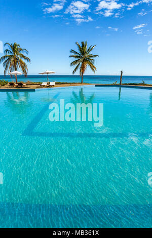 Tropical swimming pool overlooking the sea Stock Photo