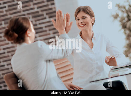 members of the business team giving each other a high five. Stock Photo