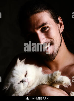 Handsome man and white kitty Stock Photo