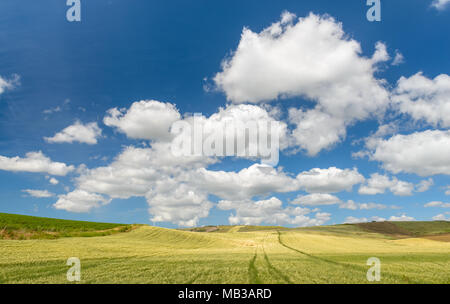 Fluffy Cumulus clouds against an azure blue Mediterranean sky Stock Photo