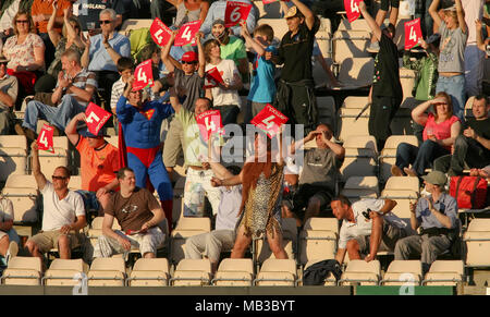 The crowd some dressed in fancy dress as Superman and a caveman cheer as a four is hit during the Twenty20 finals day at The Rose Bowl Hampshire. Stock Photo