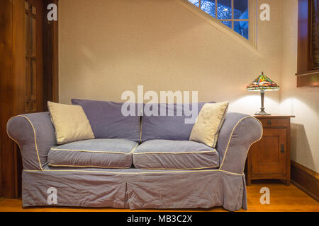 BLUE COUCH ON OAK WOODEN LIVING ROOM FLOOR Stock Photo