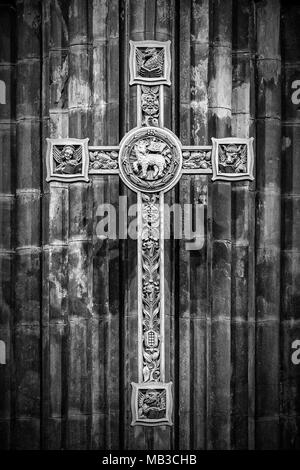 A black and white image of a beautifully carved wooden cross in the interior of Glasgow cathedral in Scotland. Stock Photo