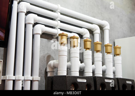 Plastic pipes of water heating system in house Stock Photo